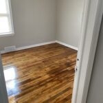 A room with wood floors and white walls.