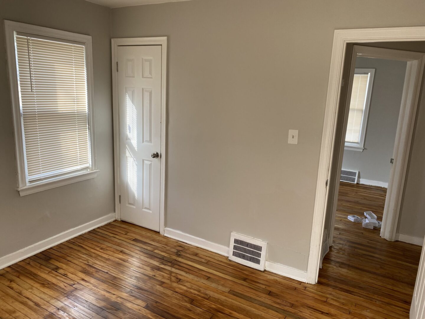 A room with wood floors and white walls.