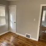 A room with wood floors and white walls.