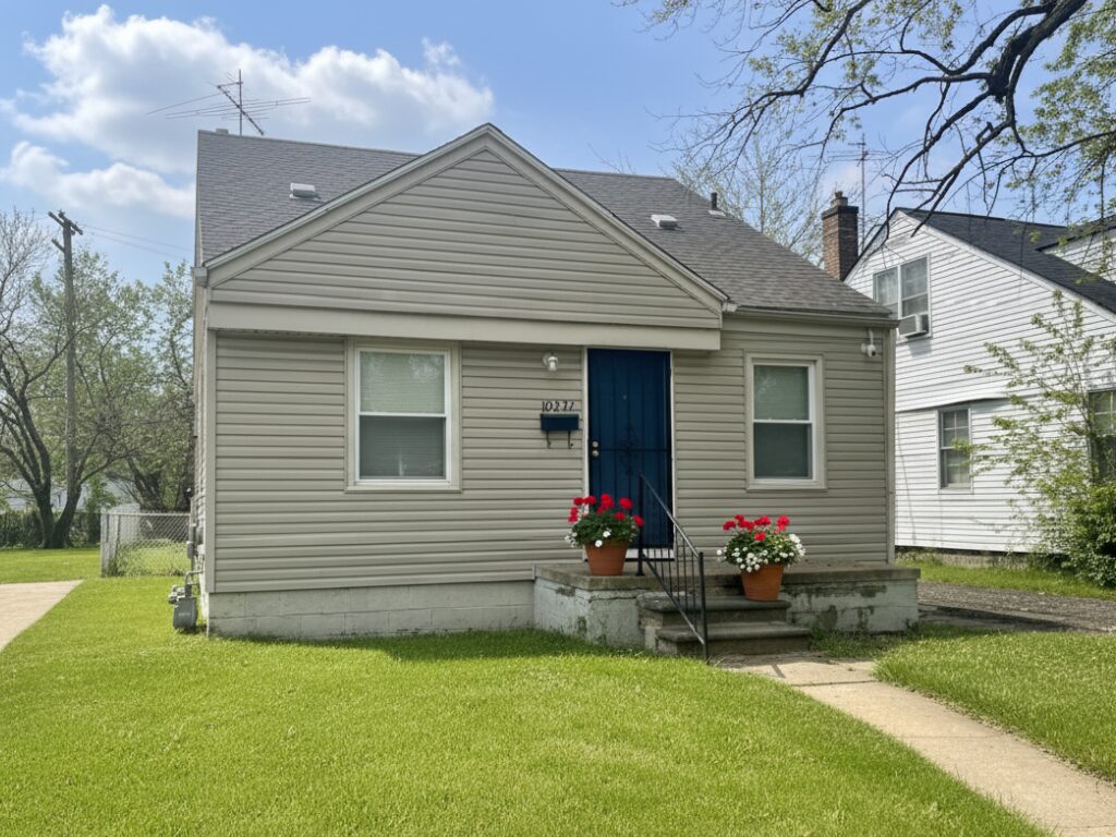 Small house with vibrant flower pots.