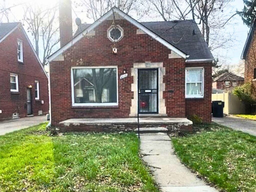 Red brick house with front yard.