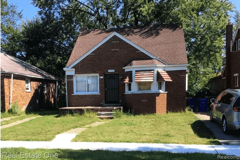 Brick house with front lawn and driveway.