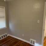Empty room with wooden floor and window.