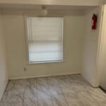 Small empty room with tiled floor.