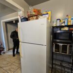 Kitchen with white fridge and microwave.