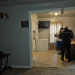 Two people in a small, tiled room.