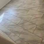 Marble-patterned tile floor in hallway.