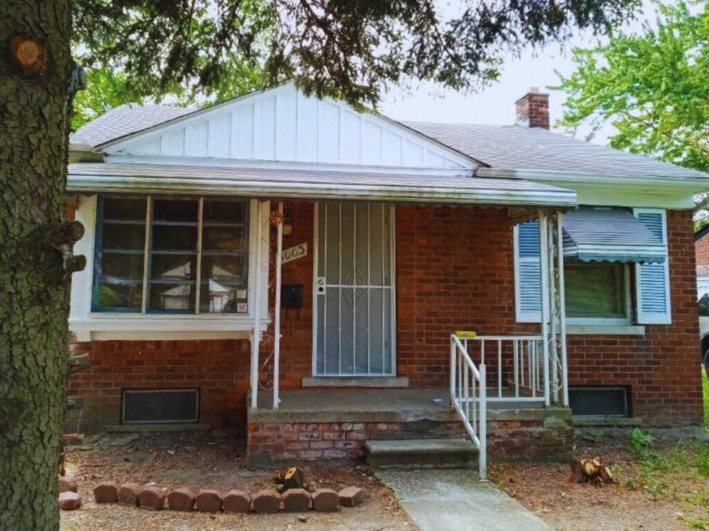 Brick house with front porch and stairs.