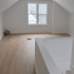 Empty attic room with wooden floor.