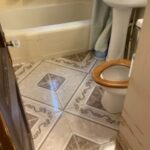 Bathroom with tiled floor and fixtures.