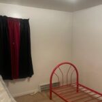 Empty room with red bed frame.