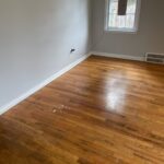 Empty room with wooden floor and window.