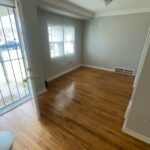 Empty room with wooden floor and window.
