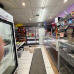 Convenience store interior with various products displayed.