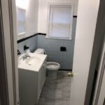 Small bathroom with blue-tiled walls.